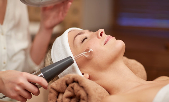 close up of young woman having face massage in spa